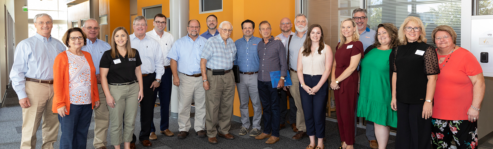 A group of people standing in the UF/IFAS Honey Bee Lab.